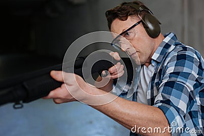 Confident skilled marksman concentrating on the activity Stock Photo