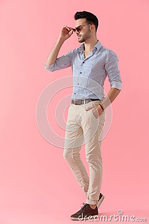 Confident smart casual man taking off his sunglasses Stock Photo