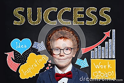 Confident smart kid businessman with Success inscription on chalkboard background. Success, career and develop concept Stock Photo