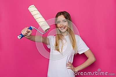 Confident Smiling Young Woman Is Holding Paint Roller Stock Photo