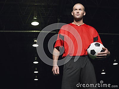 Confident Soccer Player Holding Ball Stock Photo