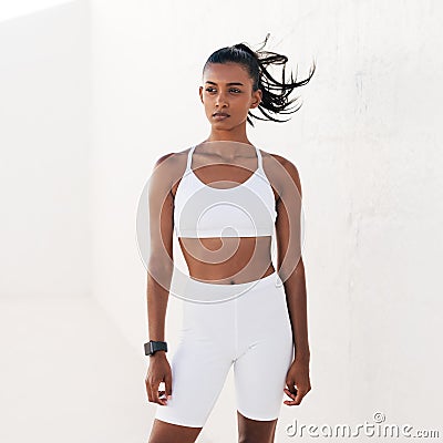 Confident sportswoman in white fitness clothes standing outdoors Stock Photo
