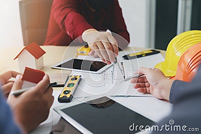 Confident team of architect working together in a office. They discussing about new startup project on desk. Architect discuss Stock Photo