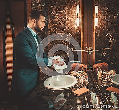 Confident well-dressed man in Luxury bathroom interior. Stock Photo