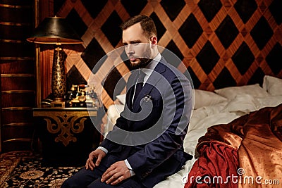 Confident well-dressed man in Luxury bathroom interior. Stock Photo