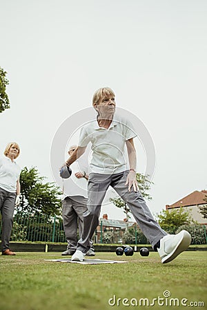 Confident Woman Lawn Bowling Stock Photo