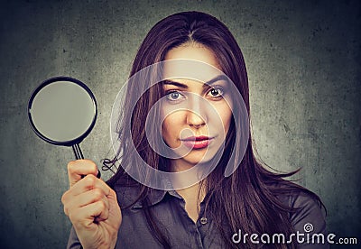 Confident woman posing with magnifier Stock Photo