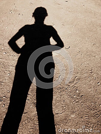 Confident woman`s shadow on construction ground Stock Photo