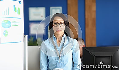 Confident young businesswoman in corporation office, wearing glasses Stock Photo