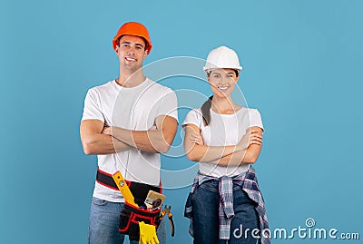 Confident young couple in hard hats ready for house repairment and renovation Stock Photo