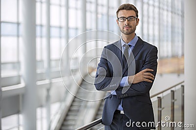 Confident Young Executive Arms Crossed Modern Architecture Escalator Office Building Stock Photo