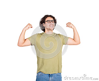 Confident young man flexing muscles imagine superpower. Nerd guy wears eyeglasses shows his strength, positive face expression Stock Photo