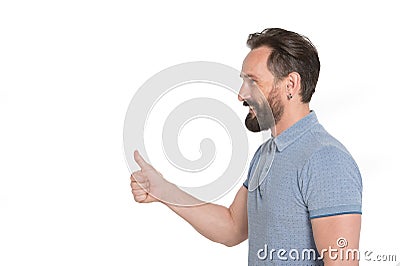 Confident young man smiling and putting his thumb up Stock Photo