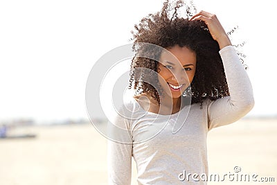 Confident young woman smiling outdoors Stock Photo