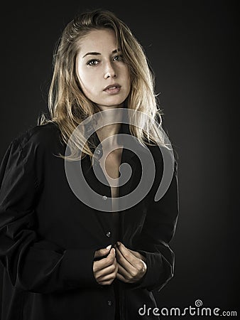 Confident young woman with unbuttoned shirt Stock Photo