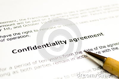 Confidentiality agreement with wooden pen Stock Photo