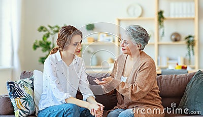 Conflict of family two generations old mother and adult daughter Stock Photo