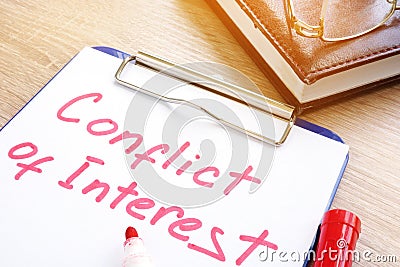 Conflict of interest written on a piece of paper. Stock Photo