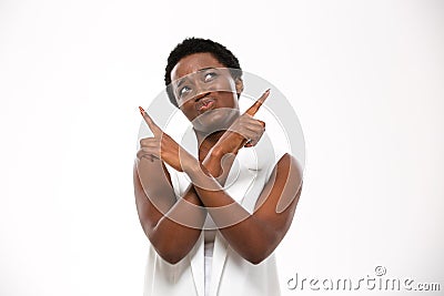 Confused african american young woman pointing up with both hands Stock Photo