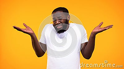 Confused afro-american man showing no idea gesture, problem hesitation, choice Stock Photo