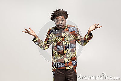 Confused afro man puzzled and say don`t know, maybe Stock Photo