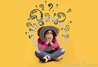 Confused black girl with question marks above her head thinking about something, unable to find solution to problem Stock Photo