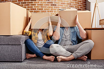 Confused couple of having to move and arrange all the packages. Concept of success, delusion, change and future Stock Photo