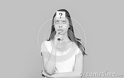 Confused female thinking with question mark on sticky note on forehead. Thinking woman with question mark. Doubtful girl Stock Photo