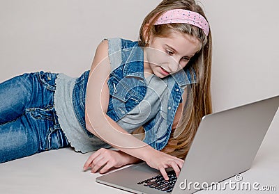 Confused little girl using a laptop Stock Photo
