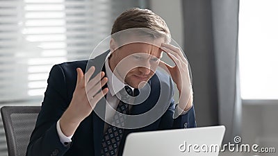 Confused male employee frustrated by laptop problems Stock Photo