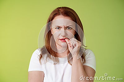 Confused puzzled redhead middle-aged mother perplexed look troubled solving troublesome situation pondering solution Stock Photo