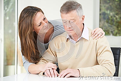 Confused Senior Man With Adult Daughter At Home Stock Photo