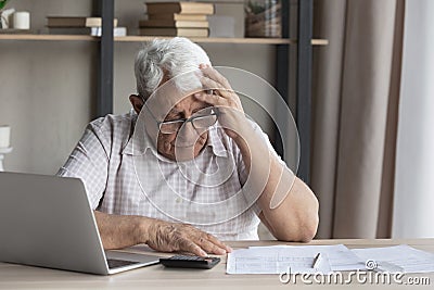 Confused stressed old mature retired 80s man having financial problems. Stock Photo