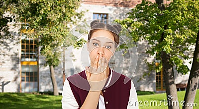 Confused student girl covering her mouth by hand Stock Photo