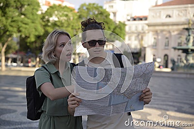 Confused tourist couple with map Stock Photo