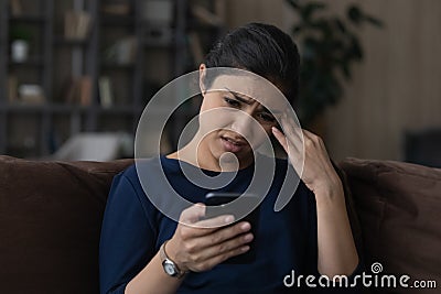 Confused unhappy indian female teenager missed important phone call Stock Photo