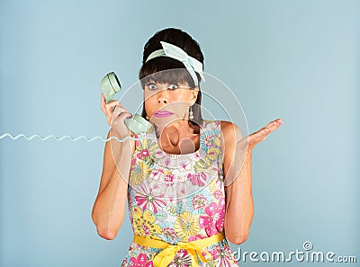 Confused woman holding telephone Stock Photo