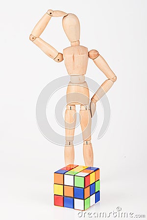 Confused wood mannequin stand next to puzzle confused before attempt to solve Editorial Stock Photo