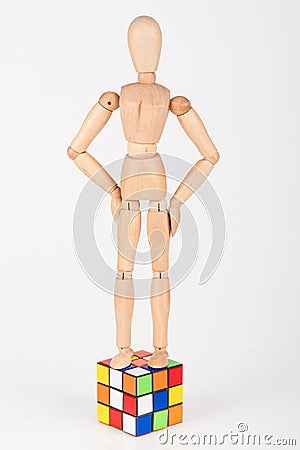 Confused wood mannequin stand on top of puzzle before attempt to Stock Photo