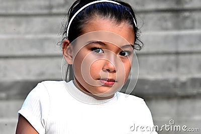 Confused Young Philippina Person Near Wall Stock Photo