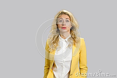 Confused young woman, grey background. Stock Photo