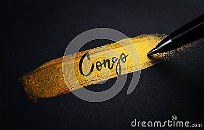 Congo Handwriting Text on Golden Paint Brush Stroke Stock Photo