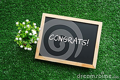 CONGRATS! text in white chalk handwriting on a blackboard Stock Photo