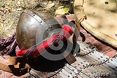 Conical helmet with nosepiece and middle east arabic type of decoration, early plate armor and kite shield Stock Photo