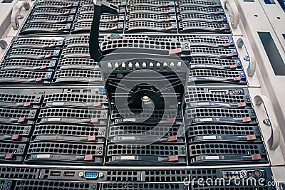 Connect a new hard drive to a stack of computer servers. Replacing a module in a powerful server hardware. Cloud Storage Stock Photo