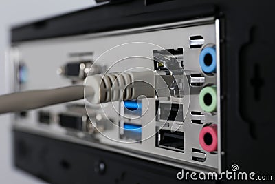Connected cable to computer system unit, closeup. Internet communication Stock Photo
