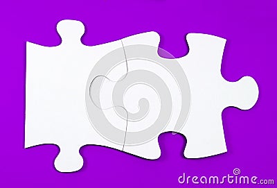 Connected puzzles on a violet background Stock Photo