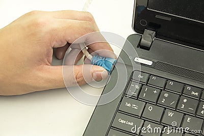 Connecting network wire with computer notebook Stock Photo