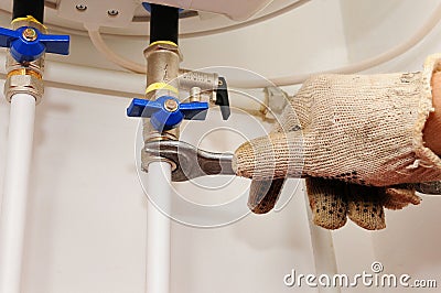 Connection of home water heater. Fixing electric water heater boiler. Domestic plumbing connections Stock Photo