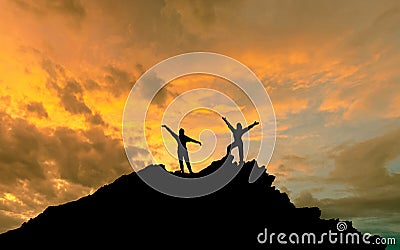 The conquest of the summit, the silhouettes of two people on top of the mountai Stock Photo